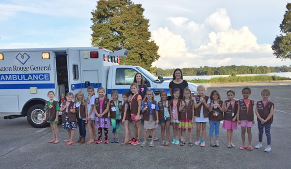 girl scouts in front of an ambulance