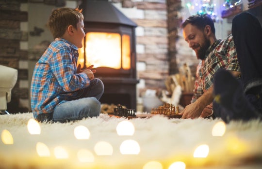 Father and son by a fireplace
