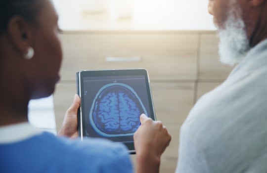 Patient and doctor reviewing brain scan 