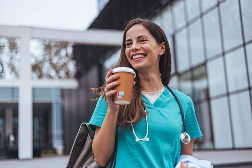 Nurse smiling with coffee