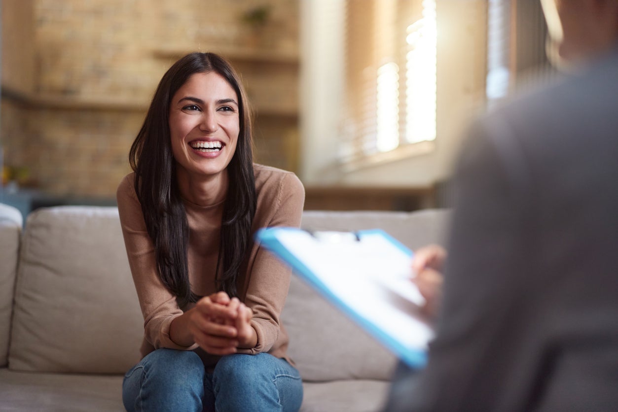 Smiling woman talking to doctor