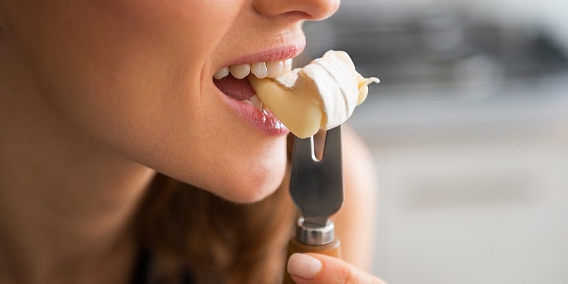 Woman eating cheese