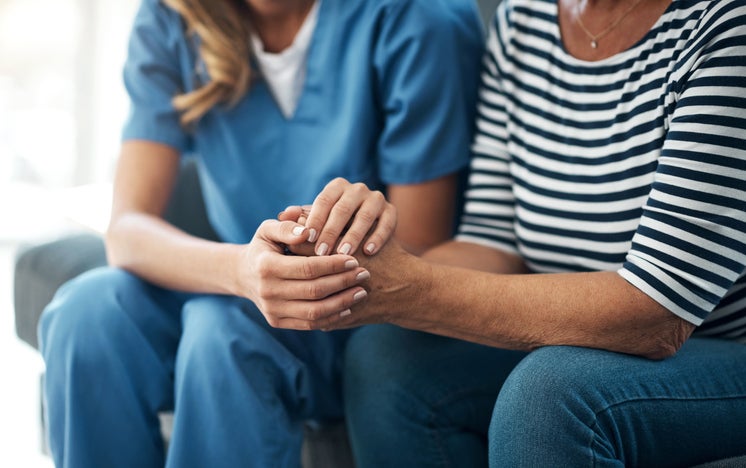 Nurse holding patient's hand
