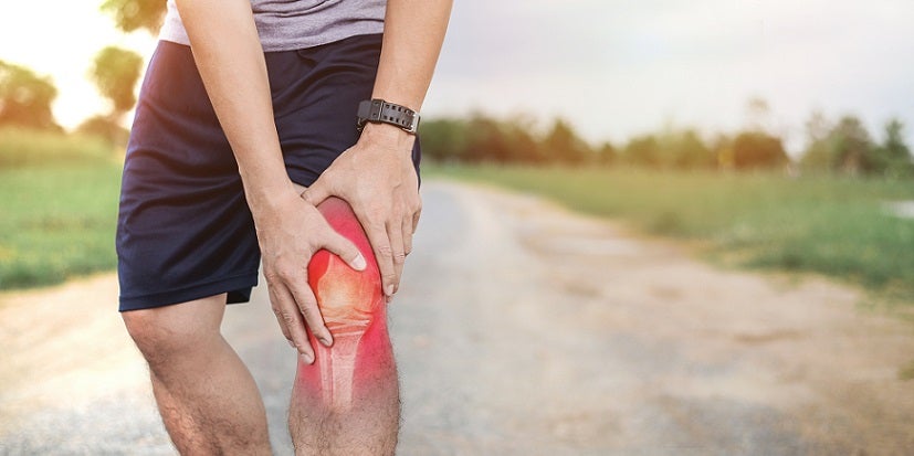 Man holding knee running