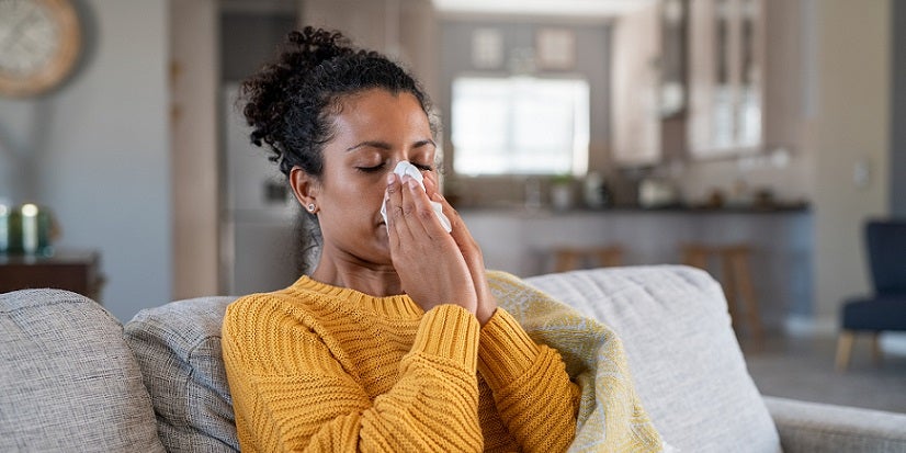 Woman blowing nose
