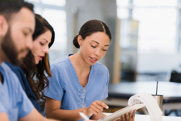 Nurses reviewing patient charts
