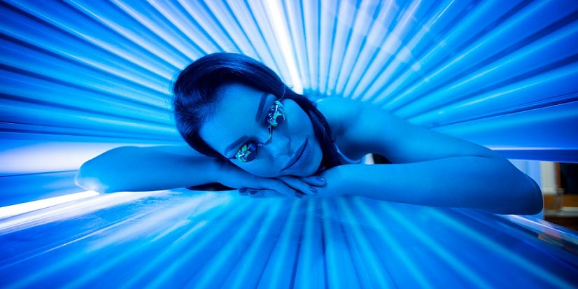 Woman laying in tanning bed 