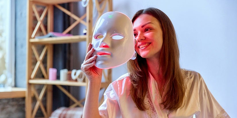 Woman with red light mask 