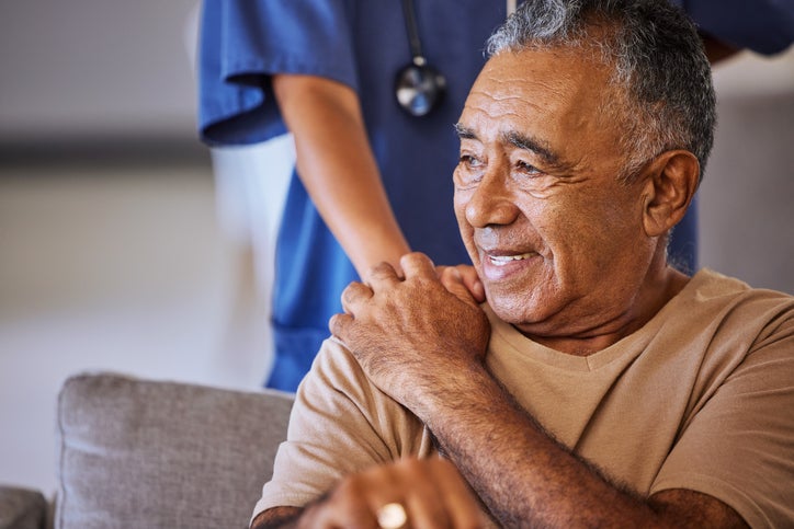 Male patient hand on shoulder