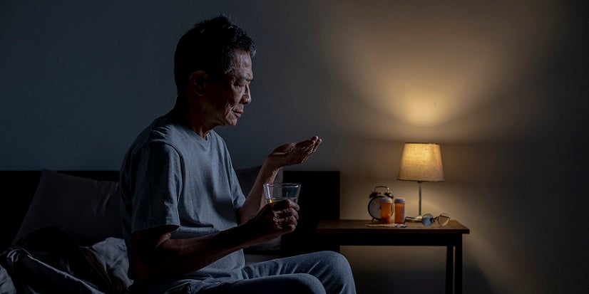 Man taking meds before bed