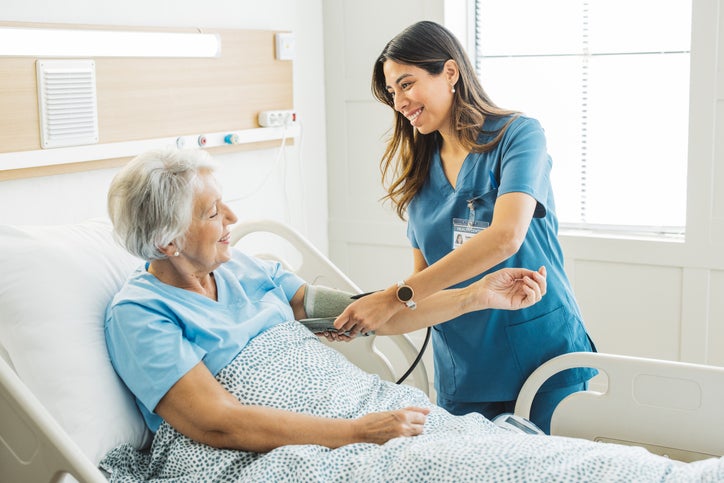 Nurse bedside with patient