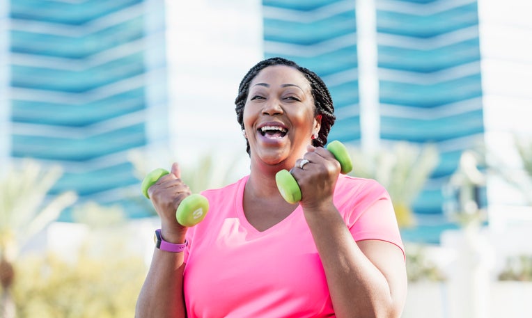 Healthy women power walking with weights