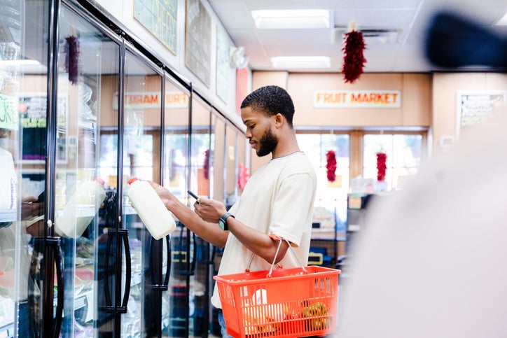 man with milk in store